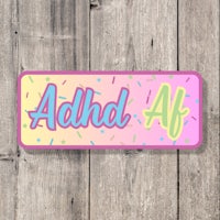a sticker with the word adhd af on it