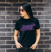 a woman wearing a black t - shirt with purple stars on it