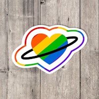 a rainbow heart sticker on a wooden background