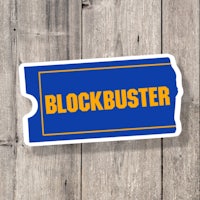 a blockbuster sticker on a wooden background