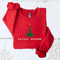a red sweatshirt with a christmas tree on it