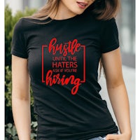 a woman wearing a black t - shirt that says hustle until the haters are hiring