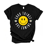 a black t - shirt with a smiley face saying good things are coming