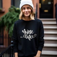 a woman wearing a black sweatshirt that says nurse life