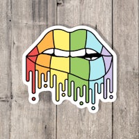 a sticker with a rainbow dripping lips on it