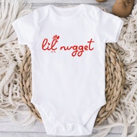 a baby onesie with the word li'nogget on it