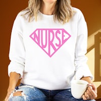 a woman wearing a white sweatshirt with the word nurse on it