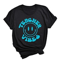 a black t - shirt that says teacher vibes with a blue smiley face