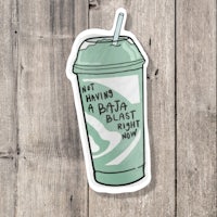a sticker with a green drink on it