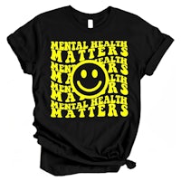 a black t - shirt with a yellow smiley face and the words mental health matters